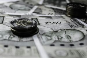 Detailed close-up of Indian currency notes and coins, highlighting financial themes.